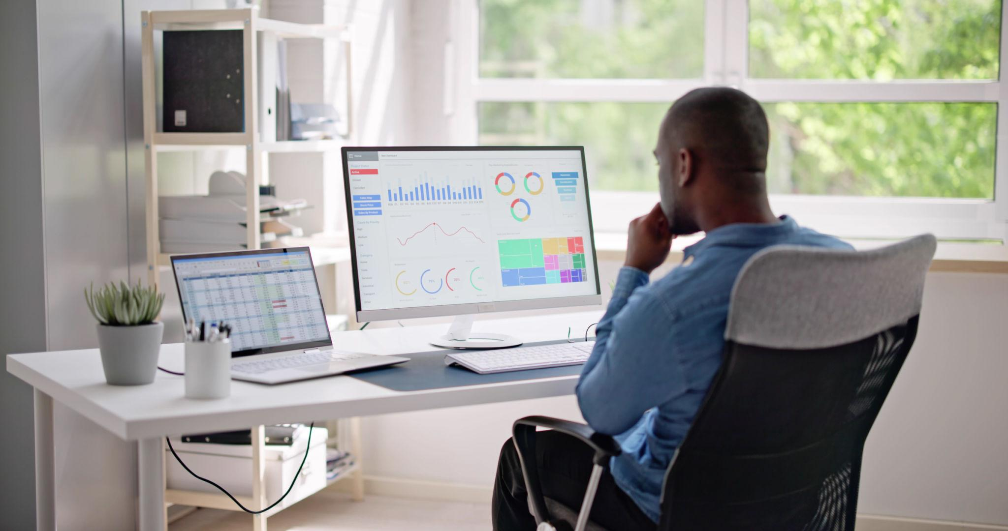 Professional reviewing business performance dashboards at their desk