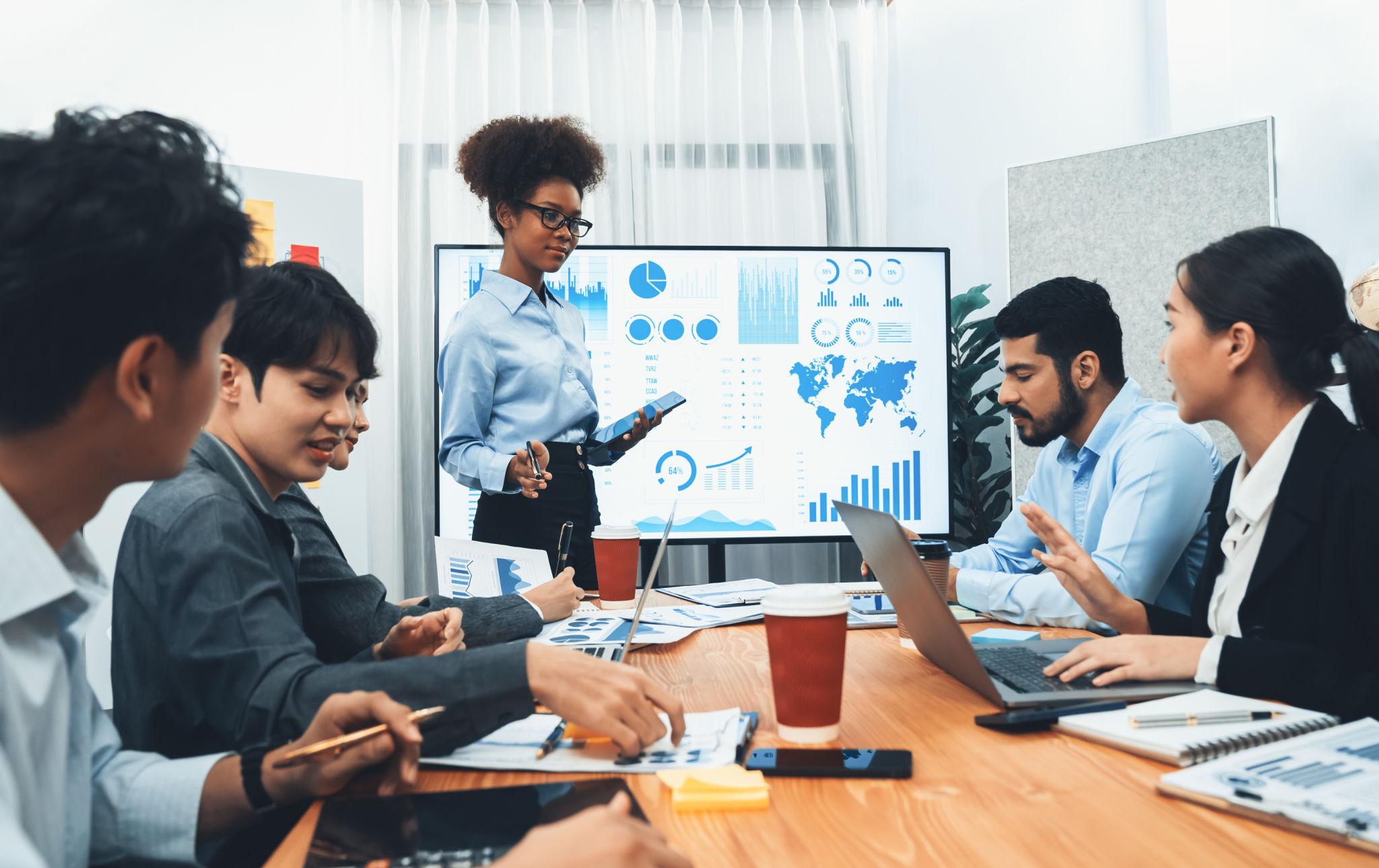 Analyst presenting performance dashboards to a meeting